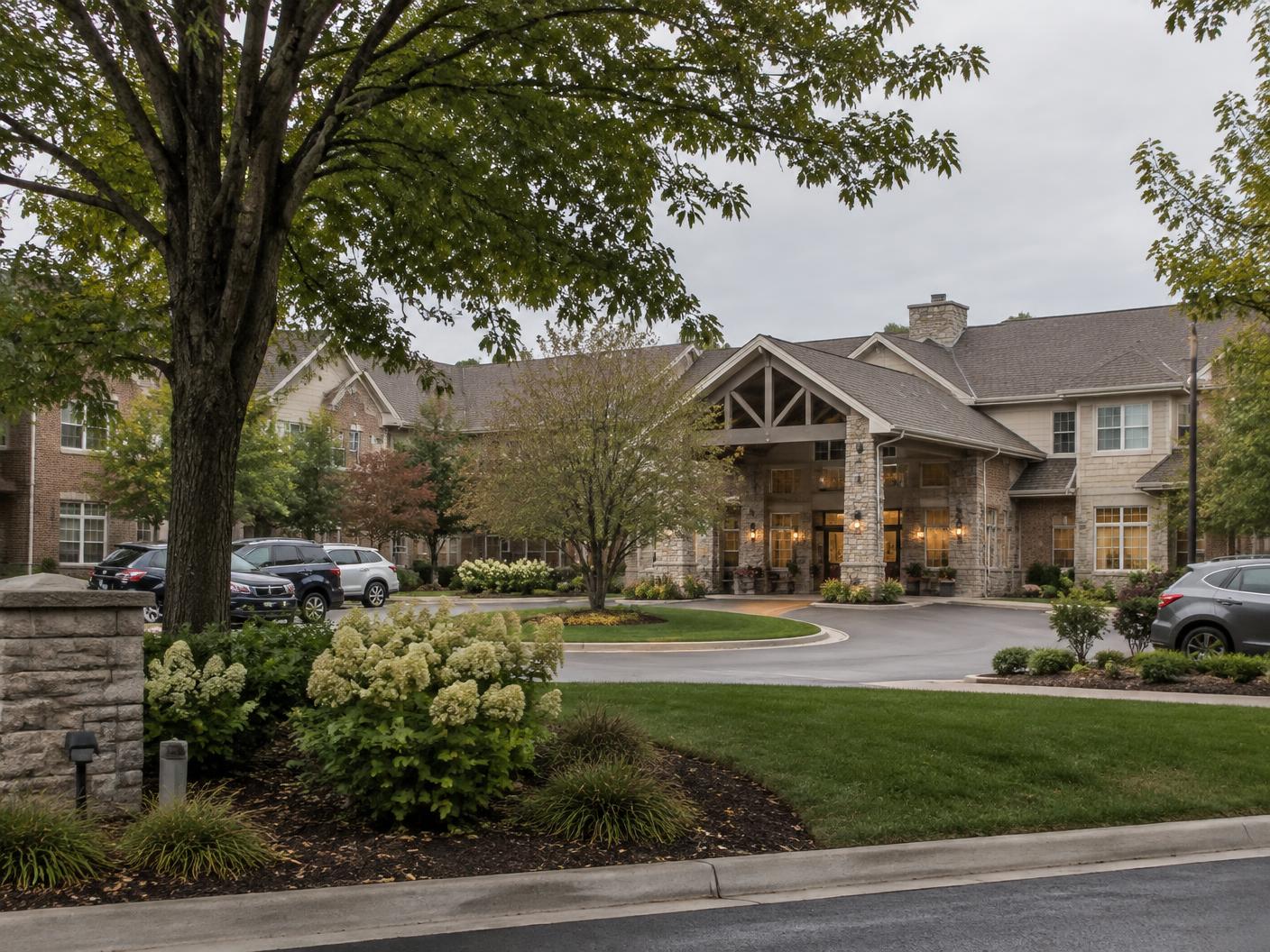 Senior living community viewed across a landscaped drive